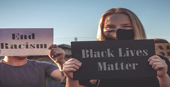 White woman holding BLM sign