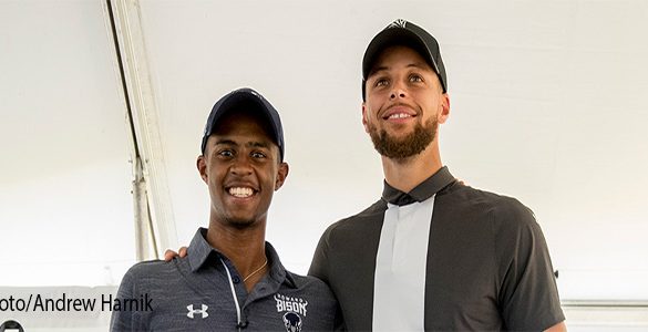 Golden State Warriors guard Stephen Curry, right, and Howard student Otis Ferguson