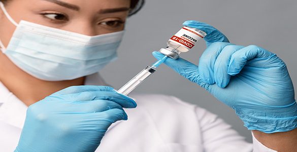 Covid-19 Vaccination. African American Female Doctor Filling Syringe With Medication For Injection, Black Therapist Lady In Protective Medical Mask Holding Vial With Coronavirus Vaccine, Closeup Shot